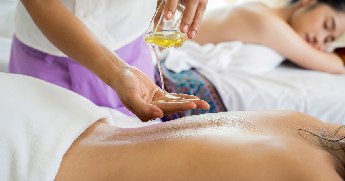 Massage therapist with AI assistant handling booking enquiries